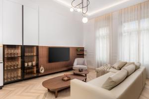 a living room with a couch and a tv at Plaza Apartments in Opatija