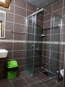 a shower with a glass door in a bathroom at şerah bungawilla in Uzungöl +12 photos