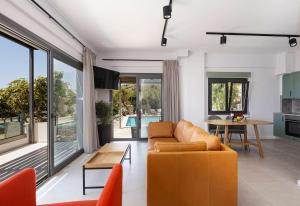 a living room with a couch and a table at Anemos Luxury Villas in Rodakino