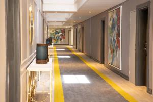 a hallway in a building with a yellow stripe on the floor at Happy Valley Hotel and Casino in Ezulwini