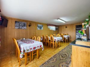 a dining room with two tables and chairs at Anna Wilczek - Pokoje z Góralską Duszą - Bukowina Tatrzańska in Bukowina Tatrzańska