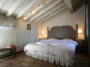 a bedroom with a large bed with two towels on it at Mas de la Forge in Arles