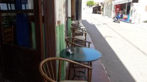 a row of chairs and a table on a street at Hotel zakros rooms-restaurant in Zekros