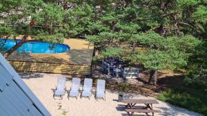 an overhead view of a picnic table and chairs next to a pool at Na Wydmach. Spokój. Cisza. Las dookoła in Hel