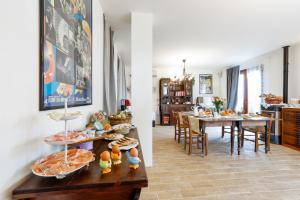 a kitchen and a living room with a table of food at B&B La Lavanda in San Clemente +30 photos