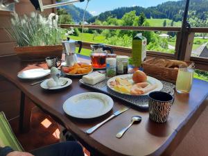 a table with a breakfast of eggs and fruit on it at Ferienwohnung Woody in Sankt Urban