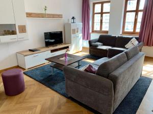 a living room with a couch and a coffee table at Familienapartment An der Frauenkirche in Dresden