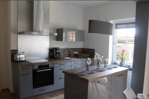 a kitchen with a stove and a counter top at Gartenidyll in Satow