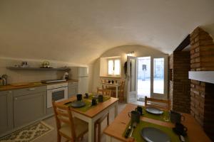 a kitchen with a table and chairs in a room at Residenza al Castello in Castellaro