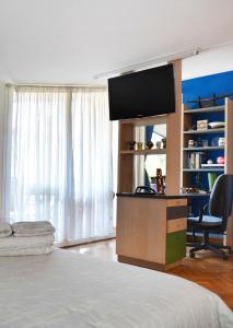 um quarto com uma cama e uma secretária com uma televisão em Apartamento en Villa con parking em Añorga-Lugariz