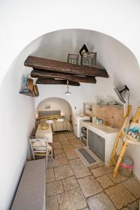 a room with a stone floor and a white ceiling at Trullo 11 in Alberobello