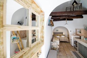 a room with a bed and a room with a mirror at Trullo 11 in Alberobello