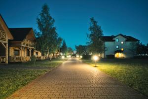 a cobblestone street at night with houses and lights at Klara in Sarbinowo