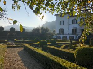 a view of a house and a garden at 4bdrm elegant apartm in Private Estate, shared Swimmingpool, Maze Garden in Florence