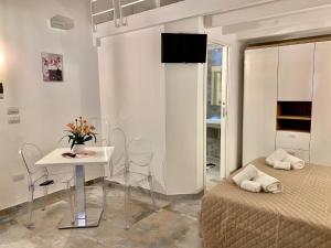 a bedroom with a bed and a table and chairs at ZiaCO' in Leverano