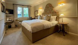 A bed or beds in a room at Holdsworth House Hotel