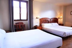 Postel nebo postele na pokoji v ubytování Hostal Antxitonea