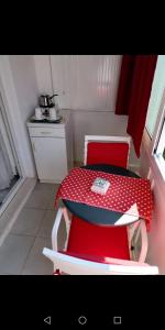 a small room with a table and a red chair at Room Dragica in Dubrovnik