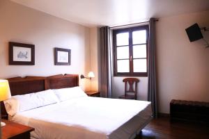 Postel nebo postele na pokoji v ubytování Hostal Antxitonea