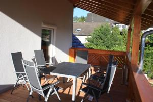 a patio with a table and chairs on a deck at Gästehaus Wacker in Ringsheim