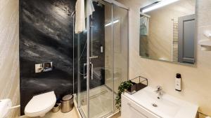 a bathroom with a shower and a toilet and a sink at HOTEL ANGEL SOFIA in Fălticeni +67 photos