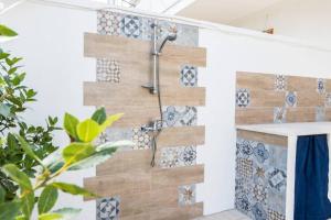 a bathroom with a wooden wall with a shower at Villa Paola by Le Dimore di Paola - Salento in Torre dell'Orso +40 photos