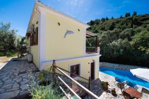 a house with a swimming pool next to a building at Delphinus Villa Nefeli in Agios Nikitas
