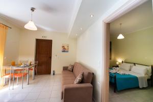 a living room with a couch and a table at Delphinus Villa Nefeli in Agios Nikitas