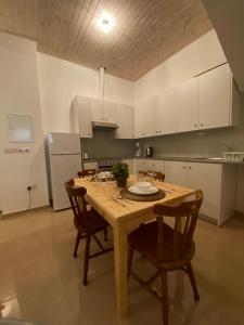 a kitchen with a wooden table and chairs at Central Suites Perikleous 53 Down Town Nicosia By Platform 357 in Nicosia