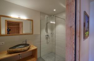 a bathroom with a glass shower and a sink at Krummholzhütte in Haus im Ennstal