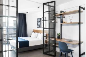 a hotel room with a bed and a desk and a ladder at PAME House in Athens