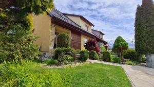 a house with a garden in front of it at Penzion PIANO in Liptovský Mikuláš