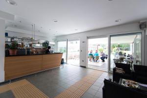 a restaurant with a counter and people sitting at tables at Erks Premantura in Premantura