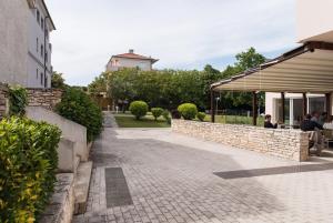 a brick walkway next to a building at Erks Premantura in Premantura