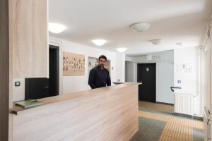 a man standing at a counter in a room at Erks Premantura in Premantura