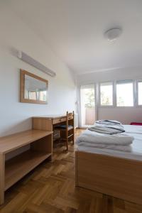 a bedroom with a bed and a desk and windows at Erks Premantura in Premantura +80 photos