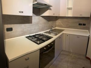 a small kitchen with a stove and a sink at Casa Entella by Vacanze in Chiavari in Chiavari +10 photos