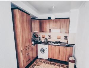 a kitchen with wooden cabinets and a white stove top oven at Коттедж в ЦО Париж in Chok-Tal