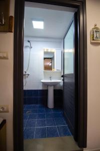 a bathroom with a sink and a shower and a toilet at Solhouse in Gjirokastër