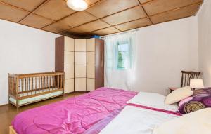 a bedroom with a large bed with purple sheets at Apartment Sveti Jakov 37 in Sveti Jakov