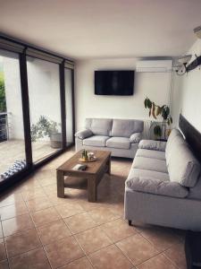 a living room with a couch and a coffee table at Casa Maria Dubova in Dubova