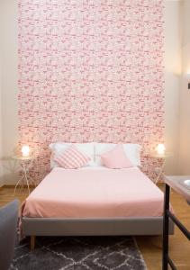 a bedroom with a bed with a red wall at B&B Donna Adelina in Naples
