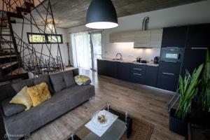 a living room with a couch and a kitchen at PIHE apartmanok in Balatonfüred
