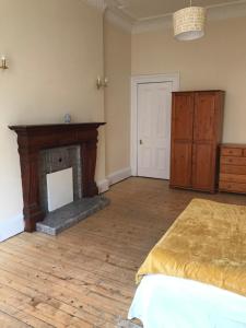 a bedroom with a bed and a fireplace at Apex Haymarket Apartment in Edinburgh