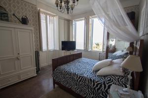 a bedroom with a bed with pillows on it at Grande appartamento in Villa con terrazza sul mare in Celle Ligure