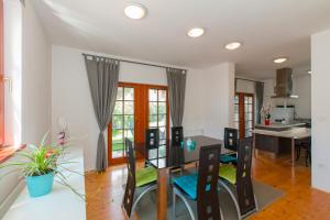 a dining room and kitchen with a table and chairs at Thirsty River Apartments in Bovec