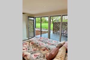 a bedroom with a bed and sliding glass doors at neue ruhige Ferienwohnung am Wald in Wüstewohlde