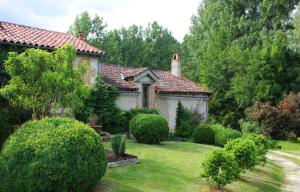 a house with a yard with bushes and trees at Romantic Mill Cottage 30 min from Bergerac France in Sourzac
