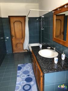 a bathroom with a sink and a mirror and a door at Magi - Il Tramonto su Palmarola in Ponza +9 photos