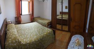 a small bedroom with two beds and a mirror at Magi - Il Tramonto su Palmarola in Ponza